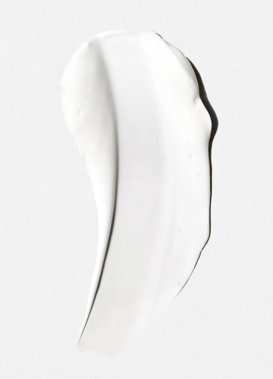white body cream spread on light grey background