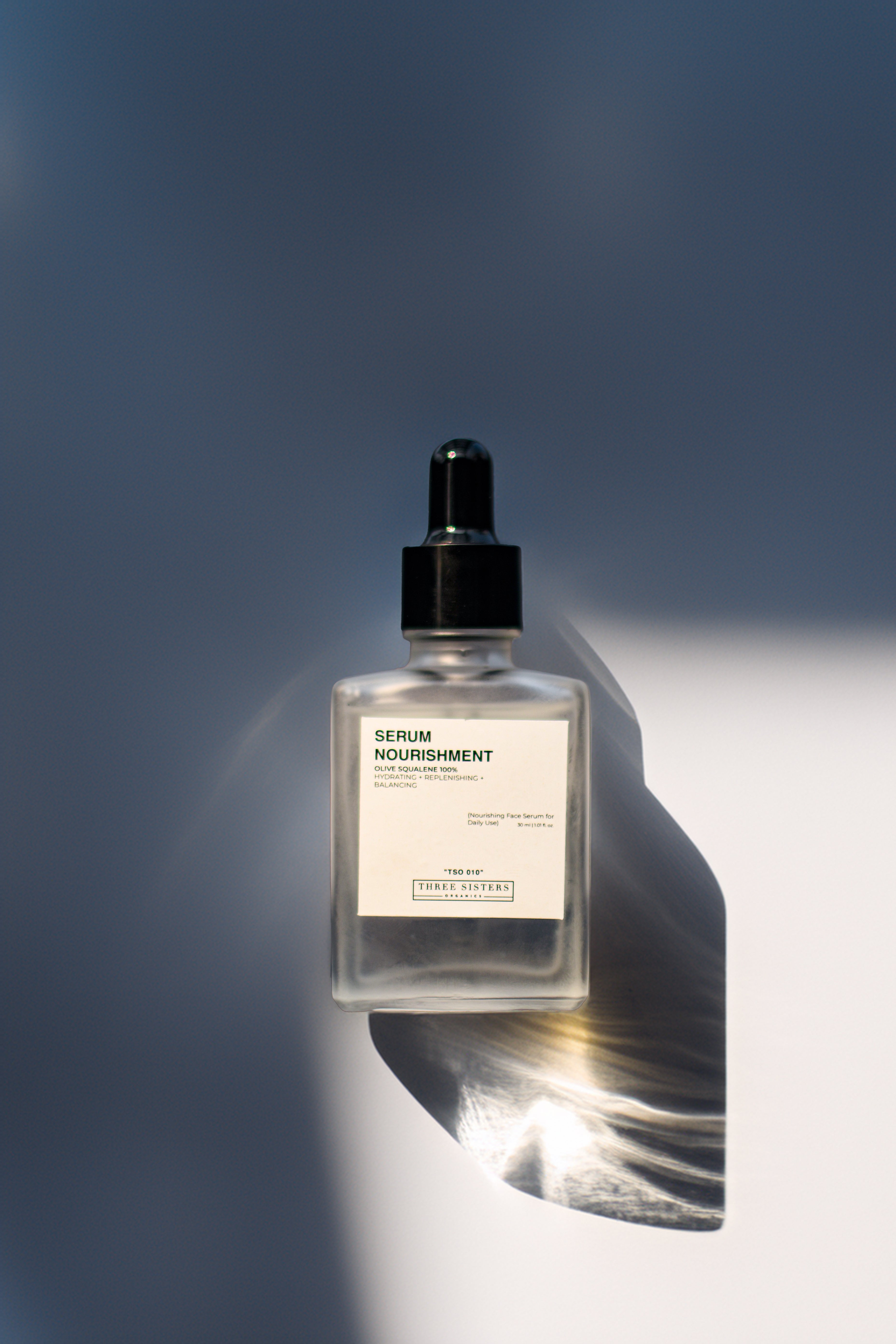 Serum Nourishment, Hydrating Face Serum, Square glass bottle with black dropper, front label, top view