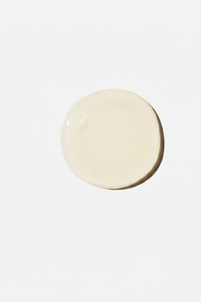 Pale yellow oil droplet on a white background