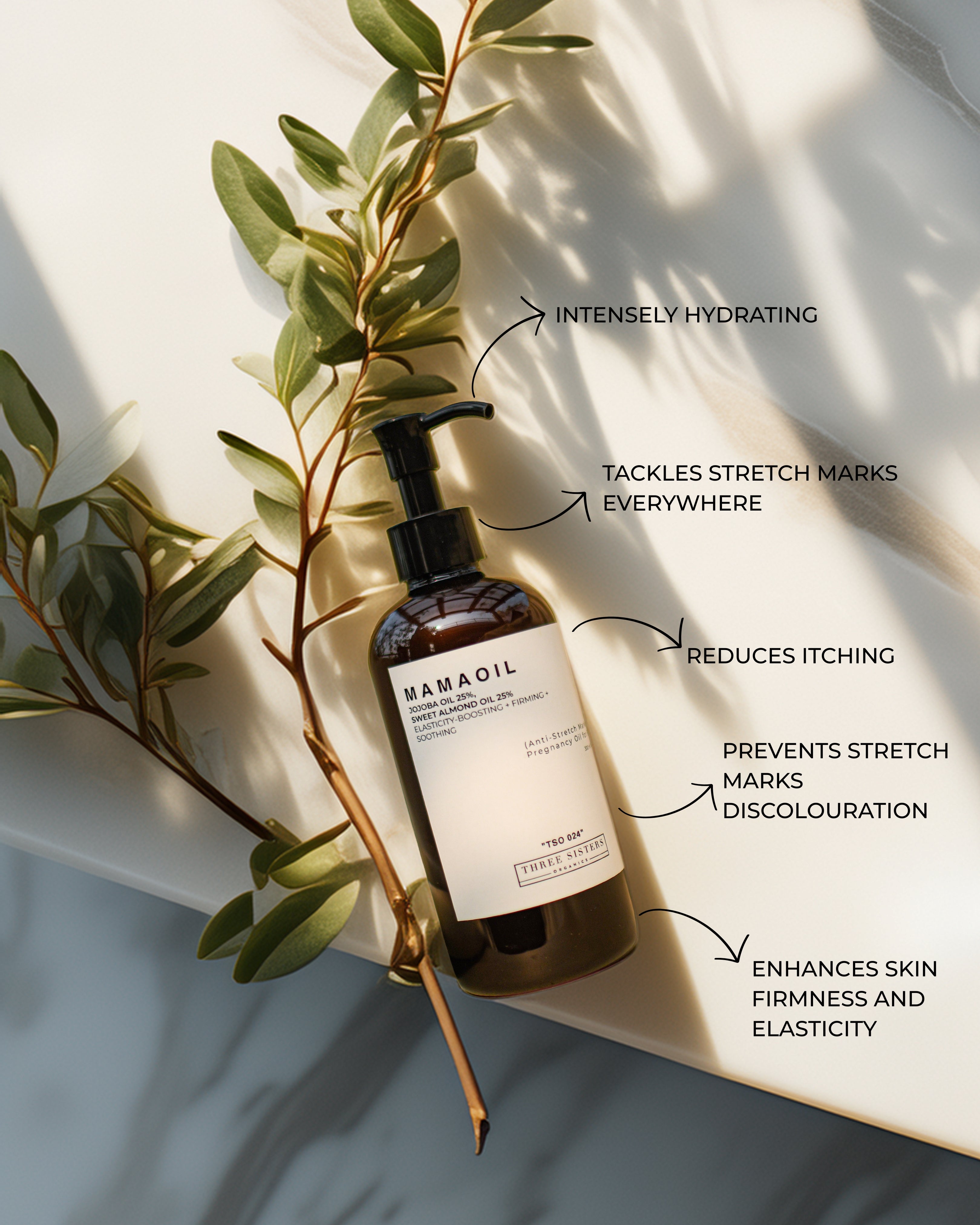 Mama Oil skincare bottle with green leaves on a textured surface