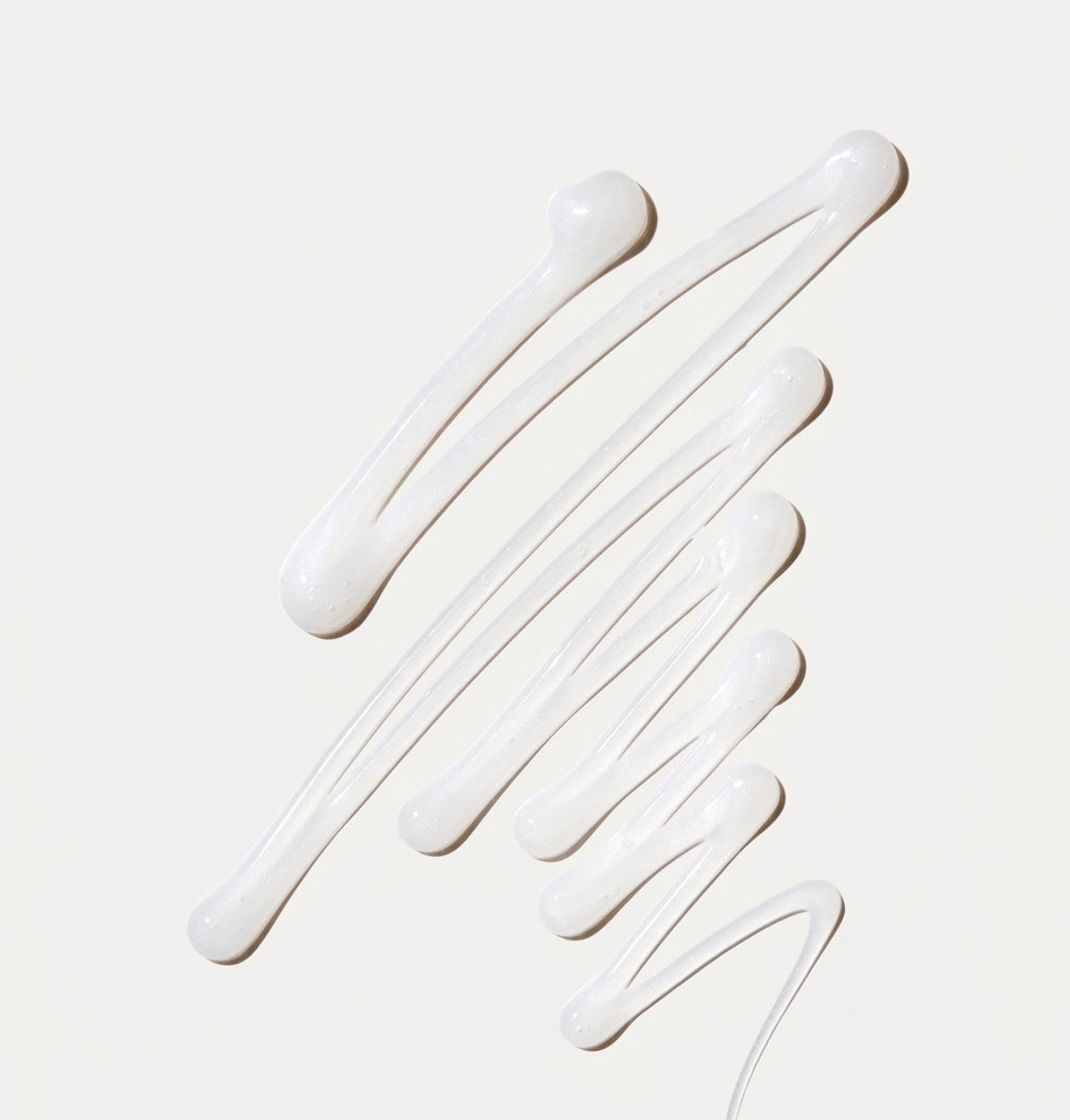 White cream cleanser in a zigzag pattern on a light beige background