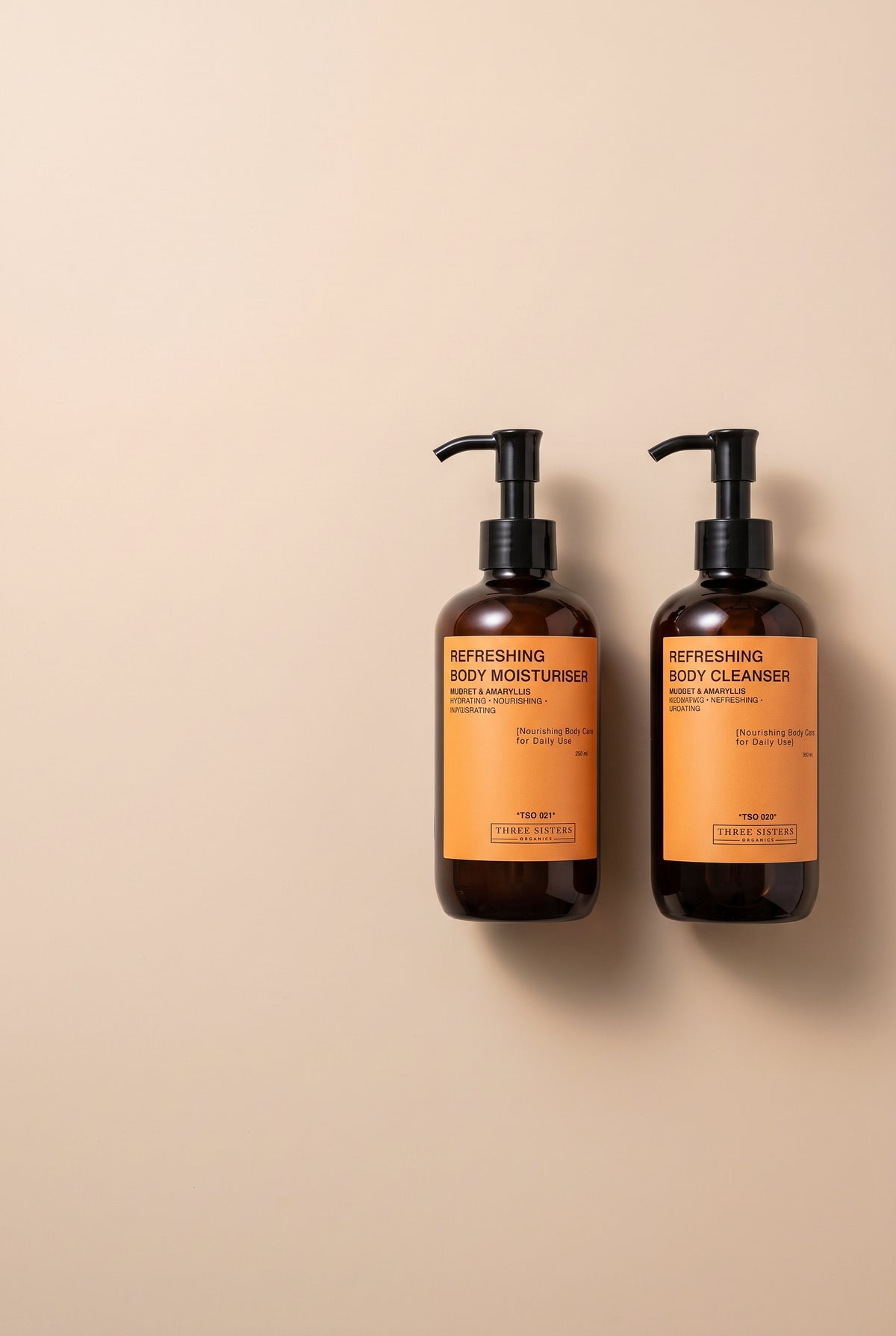 Two bottles of Refreshing Body Wash and Cream on a soft beige background