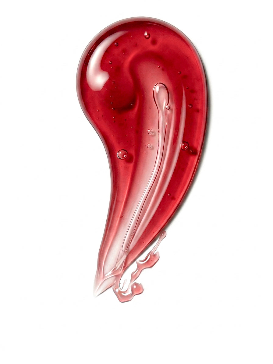 Red shower gel in a teardrop shape on a white background